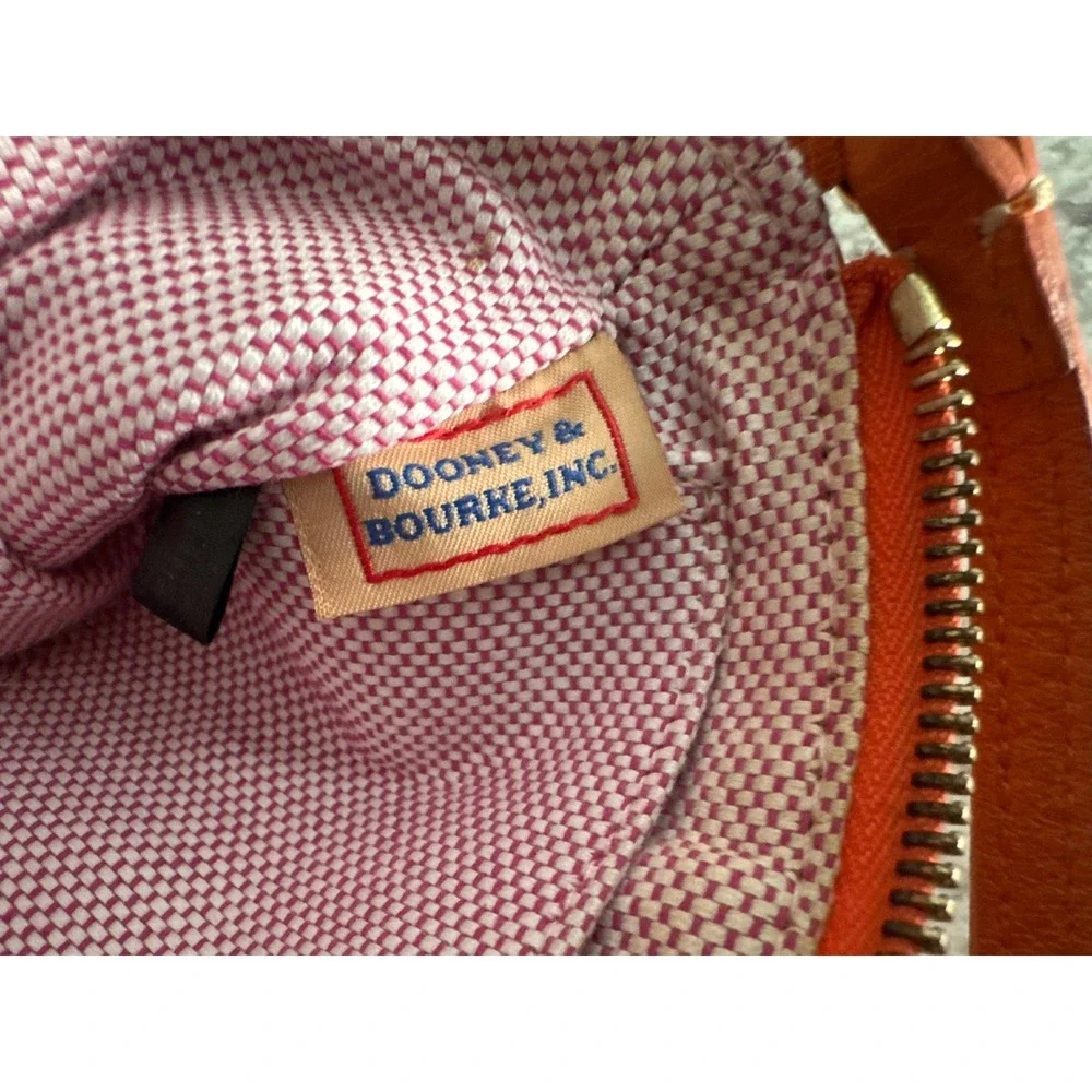 Dooney & Bourke pebble grain large slim wristlet bag in orange